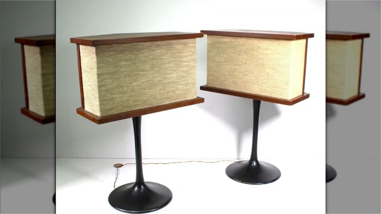 Two Bose 901 speakers sitting in a white room.