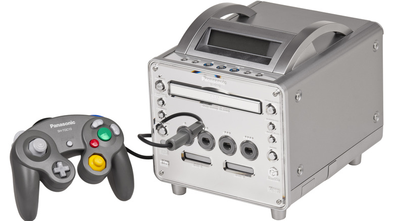 A Panasonic Q GameCube next to the Panasonic GameCube controller edition on a white background