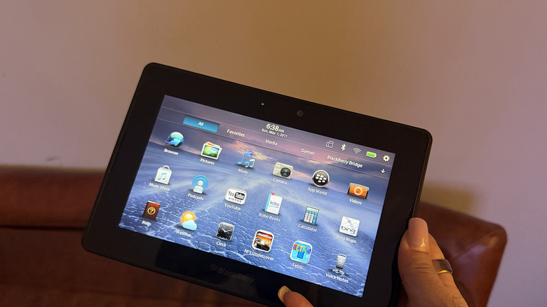 A BlackBerry Playbook in hand.
