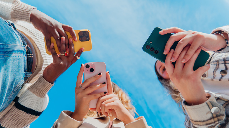 Group of young people using smartphones.