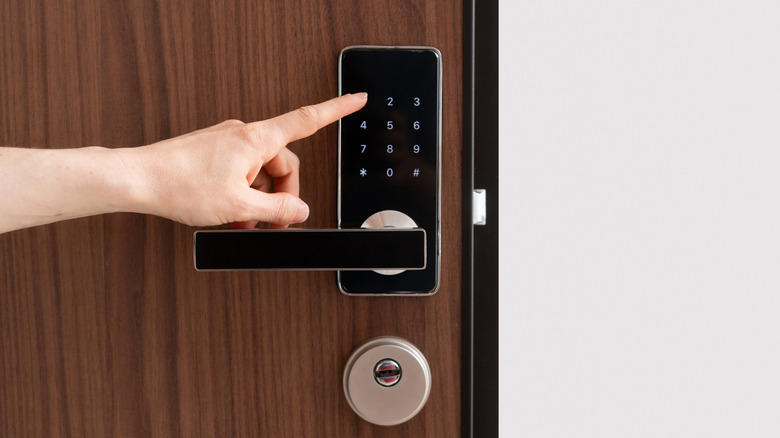 A person operating a smart lock.