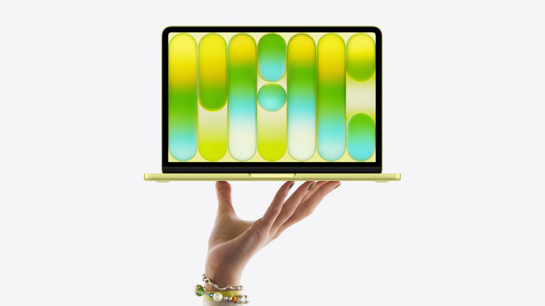 MacBook Neo being held