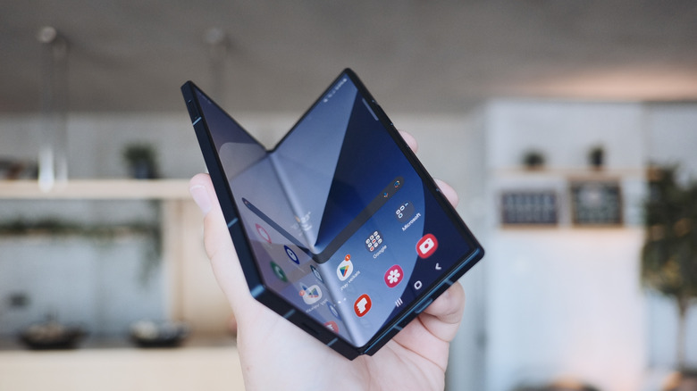hand holding galaxy z fold 6, partially folded