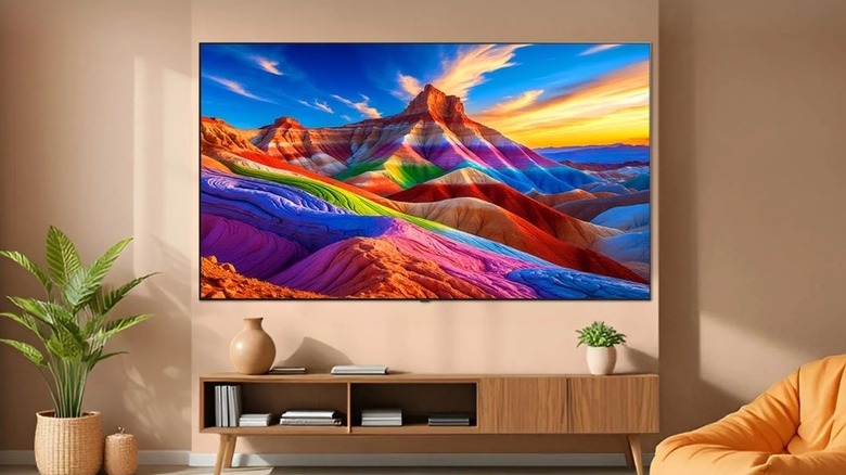 The LG B6 OLED TV mounted on a wall above a media center in a living room