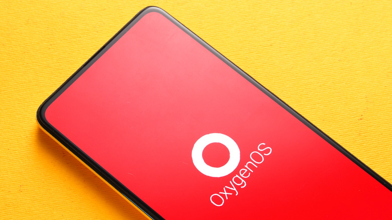 OxygenOS logo in red on a stock smartphone