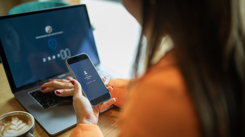 A person entering a 2FA code into a computer