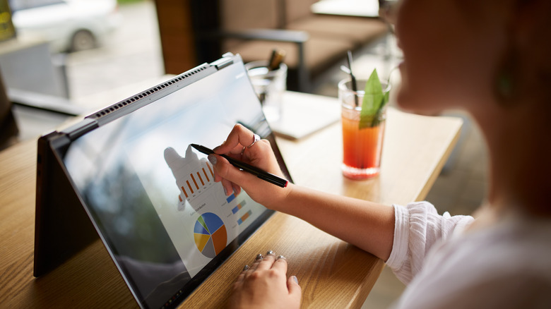 Person using a convertible laptop with touch input