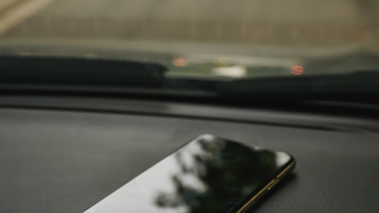 Phone sitting on dashboard of car