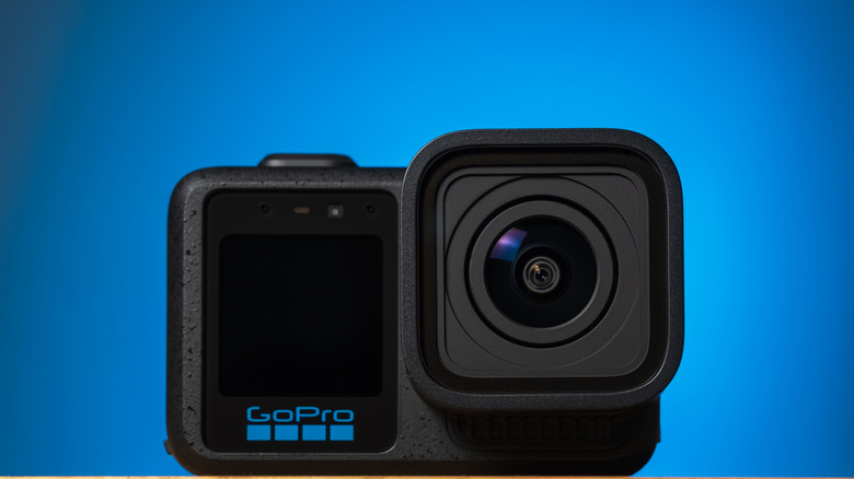 GoPro Mission One action camera displayed in a studio setting with a blue background.