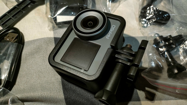 An Akaso action camera seen displayed on a table with accessories