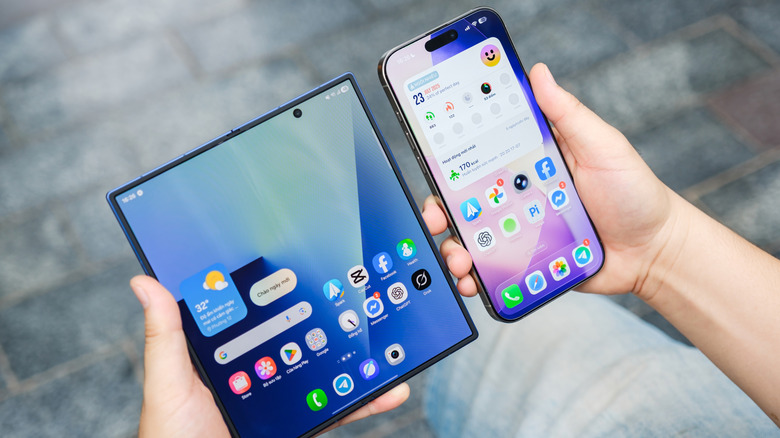 Holding the Galaxy Z Fold 7 and iPhone 16 side by side