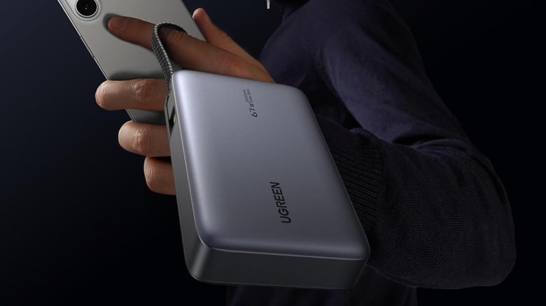 Close-up of a person holding a Ugreen Nexode 20,000 mAh Power Bank in their hand