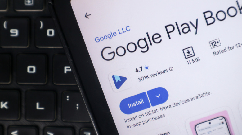 google play books app screen on a smartphone over a keyboard