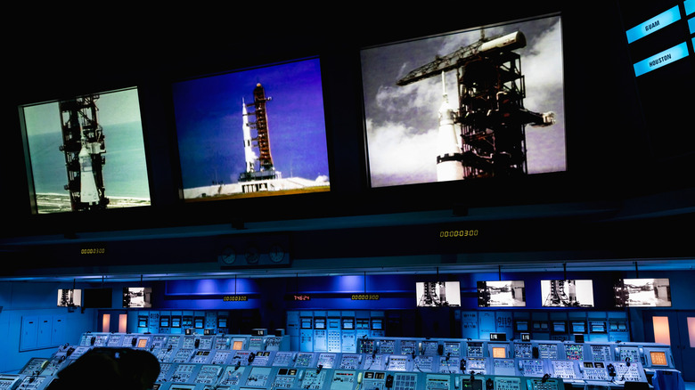 wide view of the control panels at Kennedy Space center with cameras showing rocket launch pad