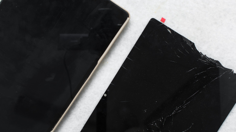 tablet side by side showing one screen with no cracks and another that has been shattered
