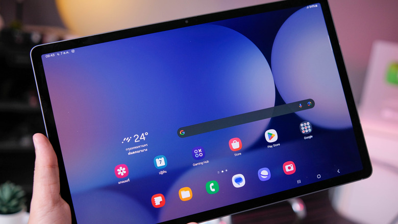 close up of person's hand holding a samsung galaxy tab s10 plus tablet