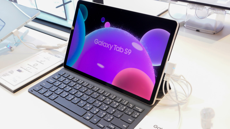 Galaxy tab s9 tablet with a magnetic keyboard, set up in a store environment