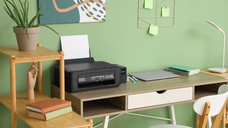 Printer sitting on a desk in an office