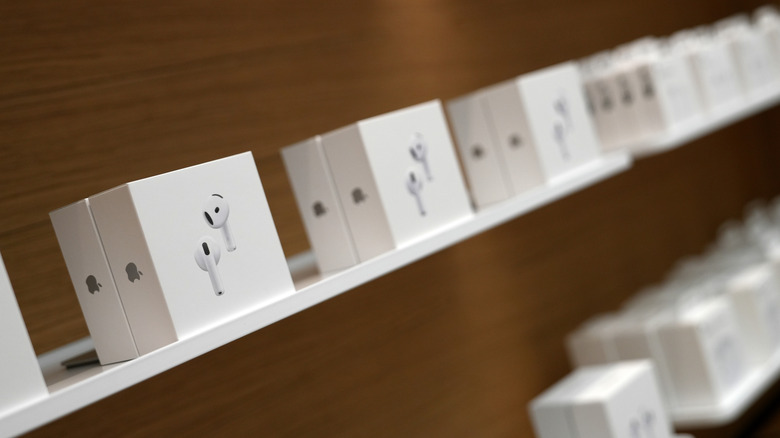 boxes of airpods 5 on shelf in store