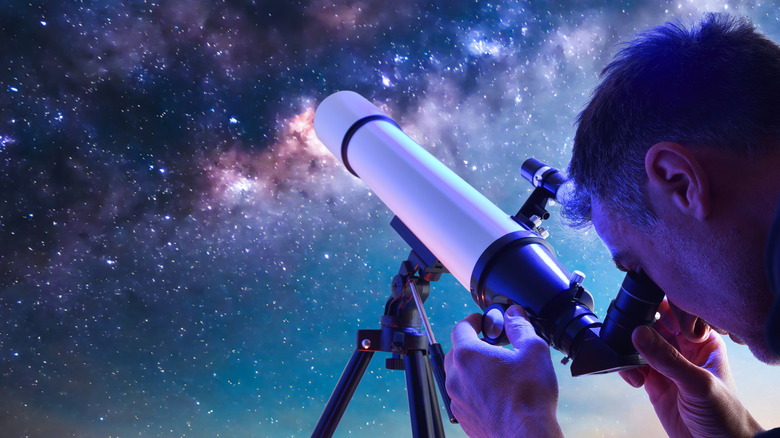 A man enjoying a beautiful view of the stars through a telescope