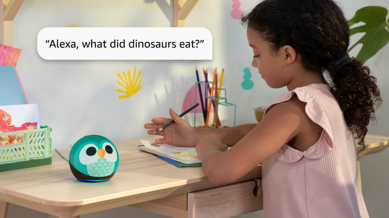 A little girl speaks to an owl design Echo Dot