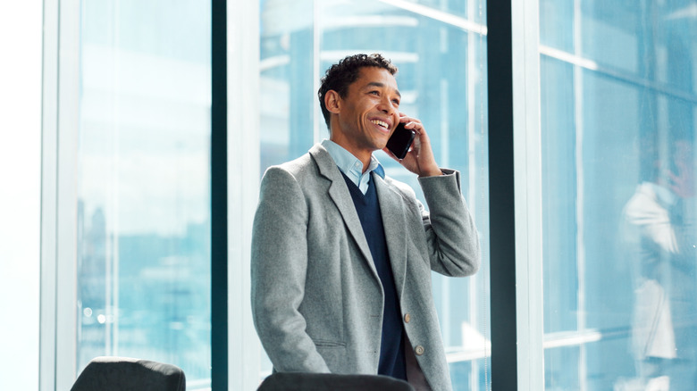 A man in an office talking on the phone