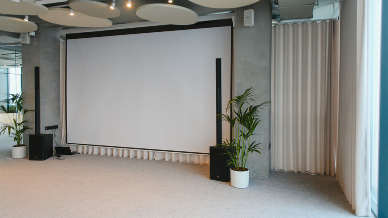 A large projection screen set up in a conference or presentation room.