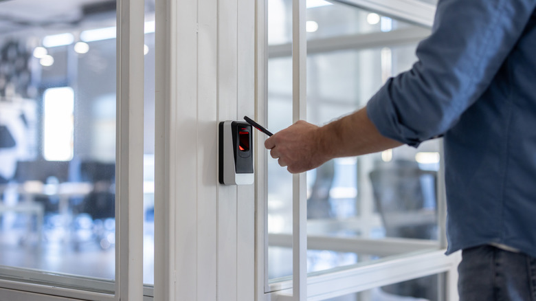 Person using an RFID key to access a locked room
