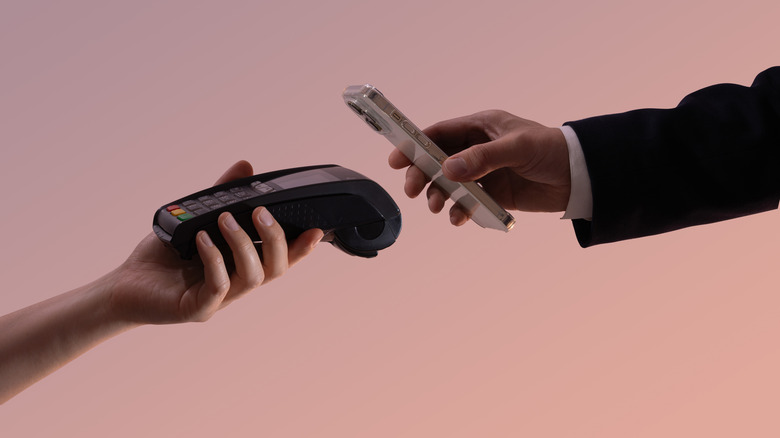 Person using contactless payment via their phone