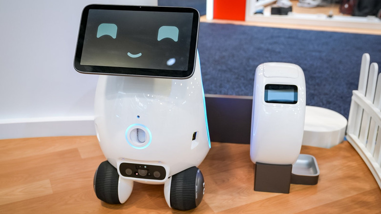 The Aura, awhite robot with a smiling face displayed on its screen