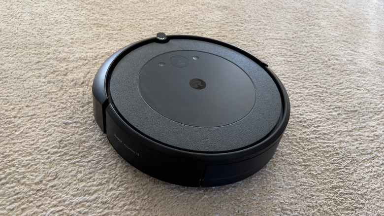 An iRobot Roomba cleaning a carpet
