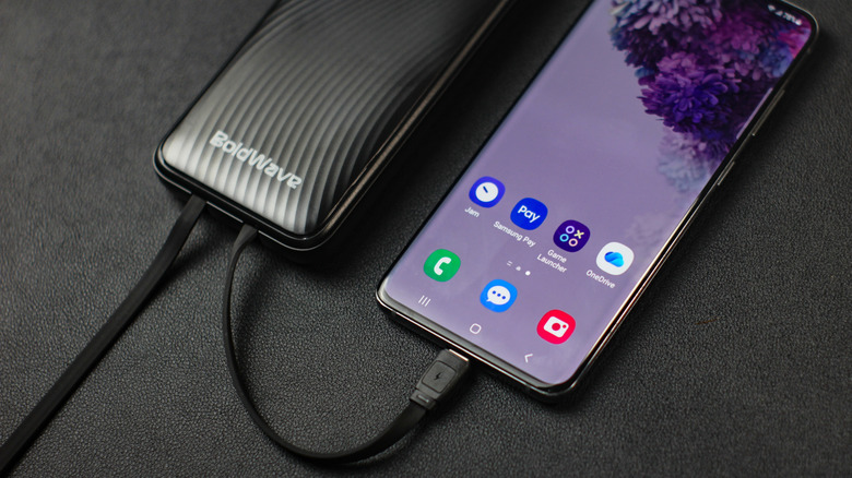 a Samsung phone that is charging from a power bank