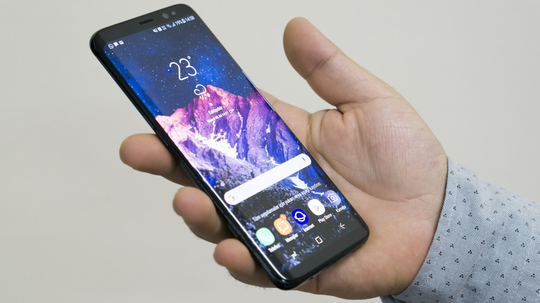 Someone holding a Samsung Galaxy S8 that shows its edge display