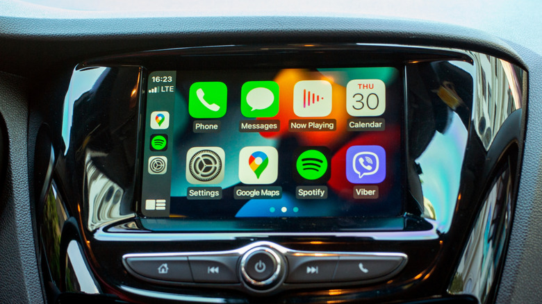 A vehicle's infotainment screen displaying several apps within Apple CarPlay