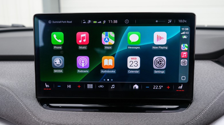 A vehicle infotainment screen displaying the CarPlay Home screen, it shows several Apple apps