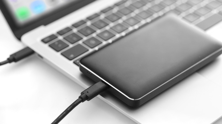 An external hard drive places on a laptop