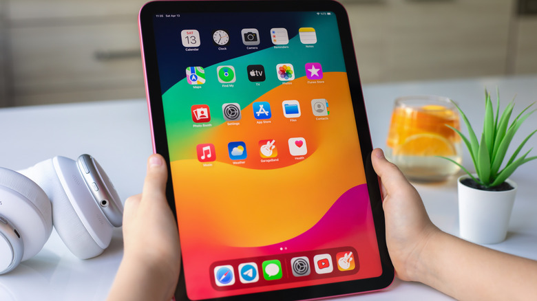 Child's hands holding an iPad.