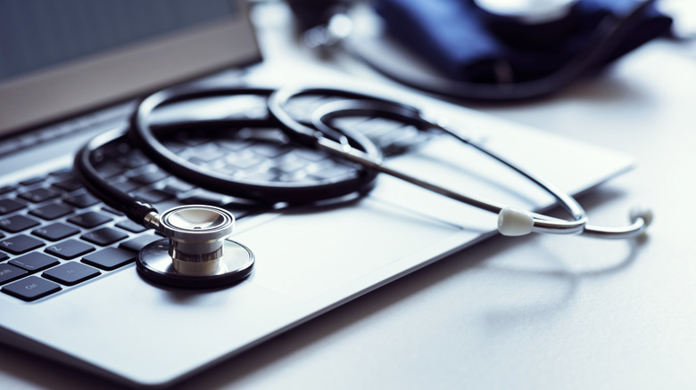 Stethoscope on top of laptop indicating need for repairs