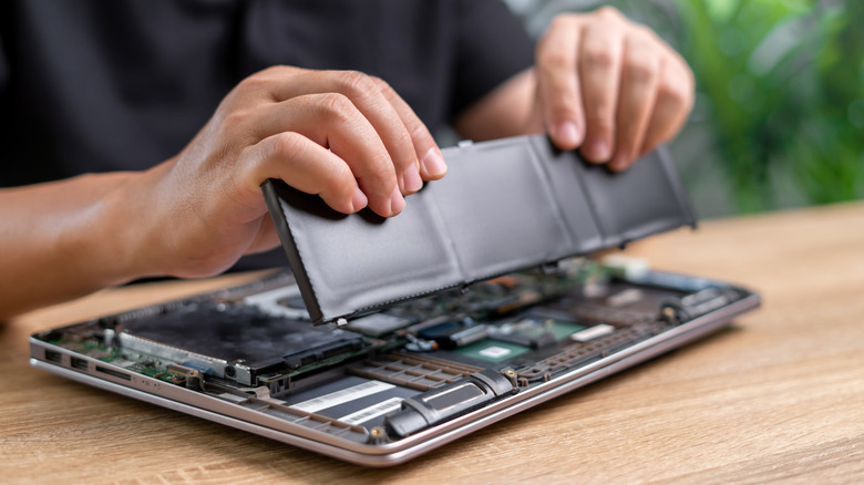 Person replacing laptop battery