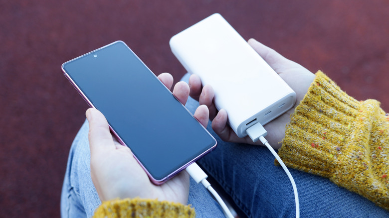 Person holding power bank charging phone