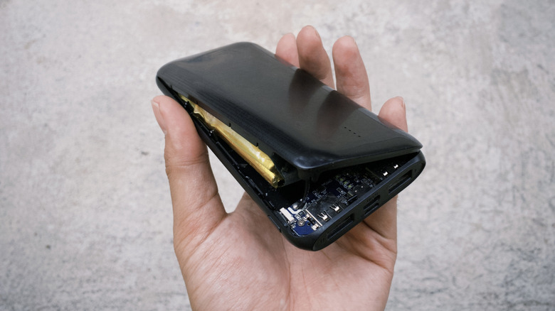 Person holding damaged power bank