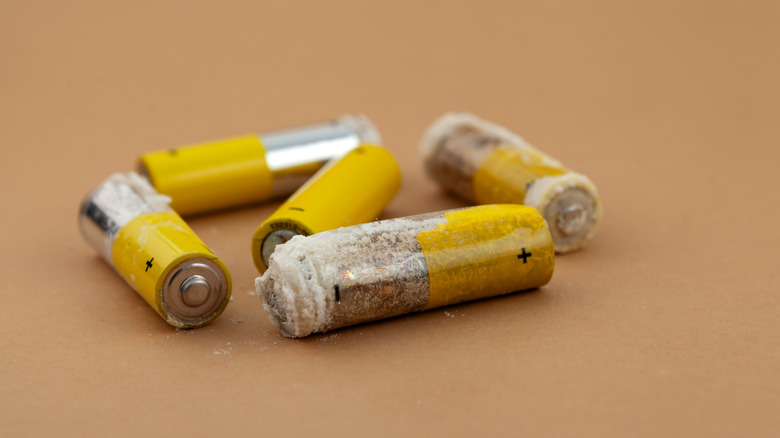 Batteries with white deposits on their shell