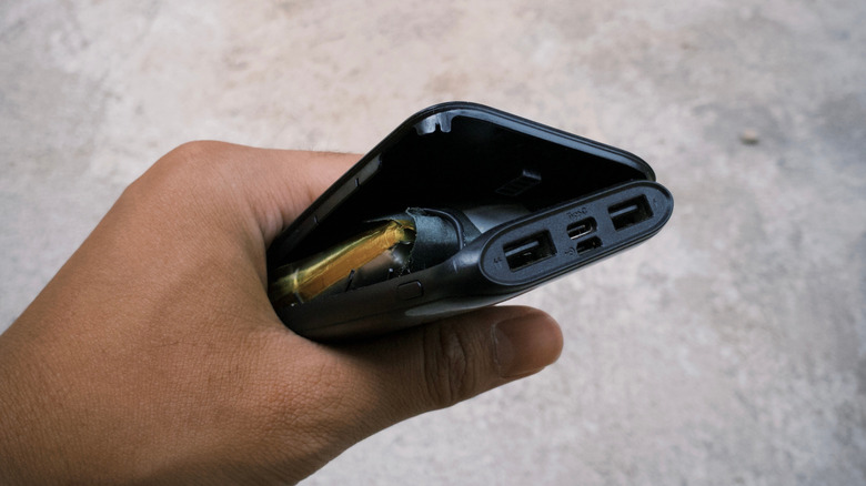 A power bank with a bulging and damaged battery