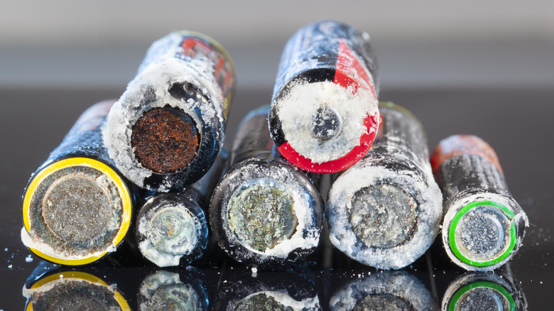 An assortment of batteries leaking electrolytes