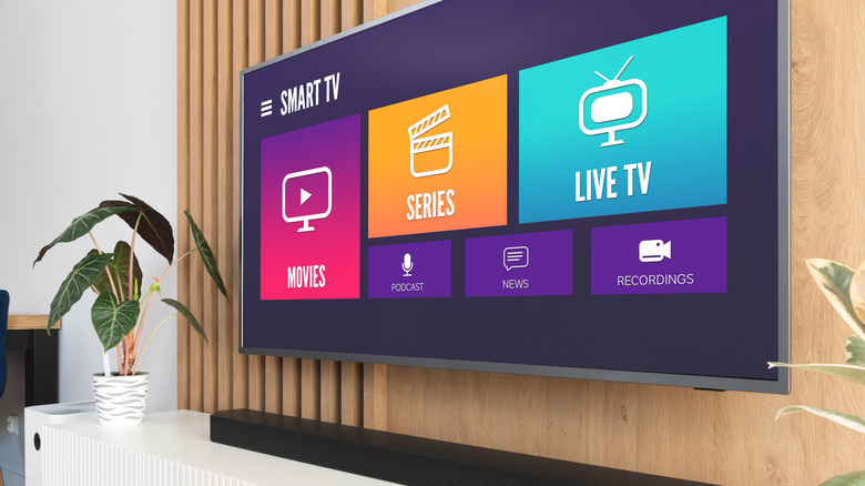 A generic image of smart TV OS displayed on the TV on a wooden wall