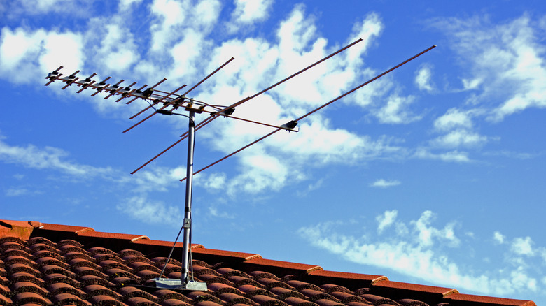 A TV antenna mounted on the roof of a house.