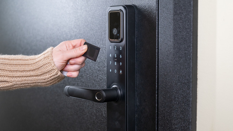Person using a keyless chip on a smart lock