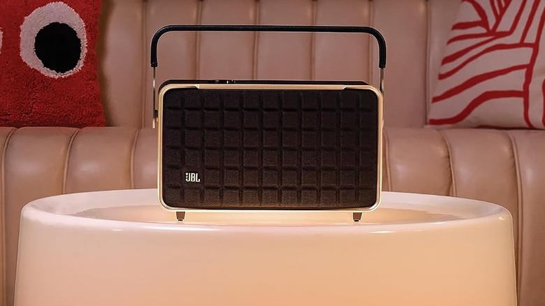 The JBL Authentics 300 on a white ottoman in a swanky living room.