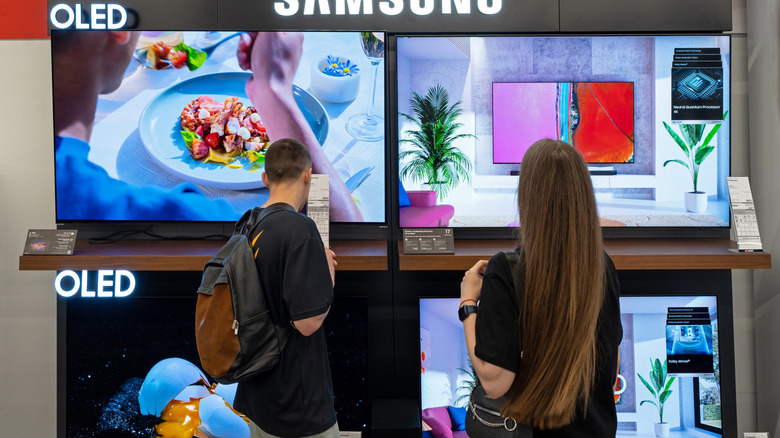 Samsung OLED TVs displayed at an electronics store