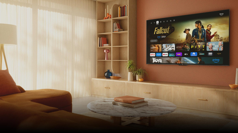 Amazon Fire TV interface displayed on a wall-mounted TV in a cozy living room.